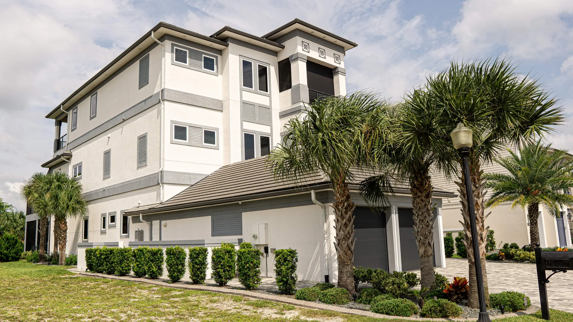 Florida estate home with arched windows and mature palms
