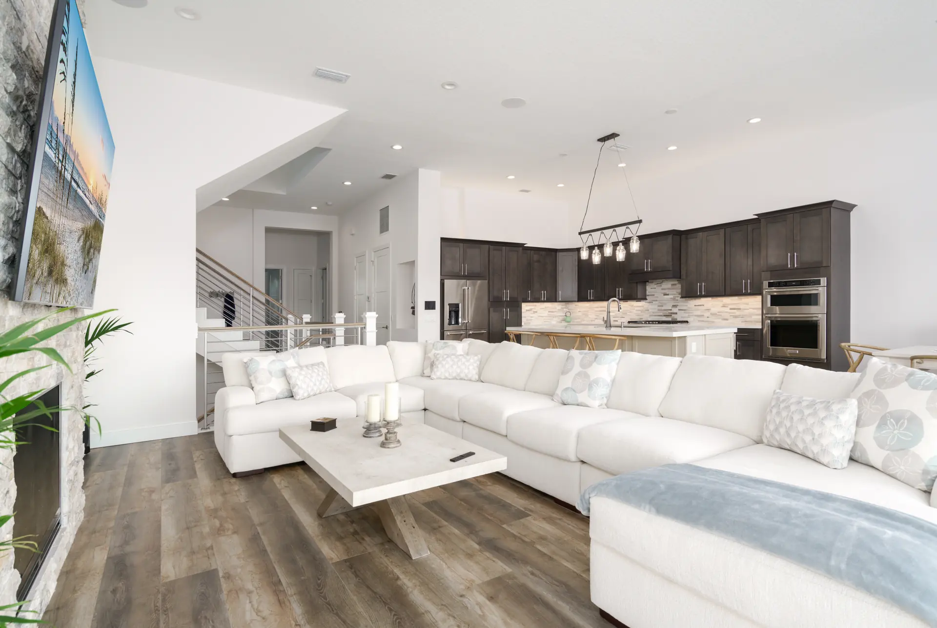 Open-concept living room and kitchen with custom finishes