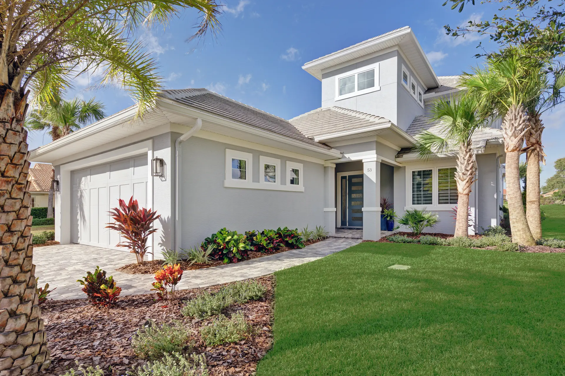 Landscaped front elevation of a custom Florida home