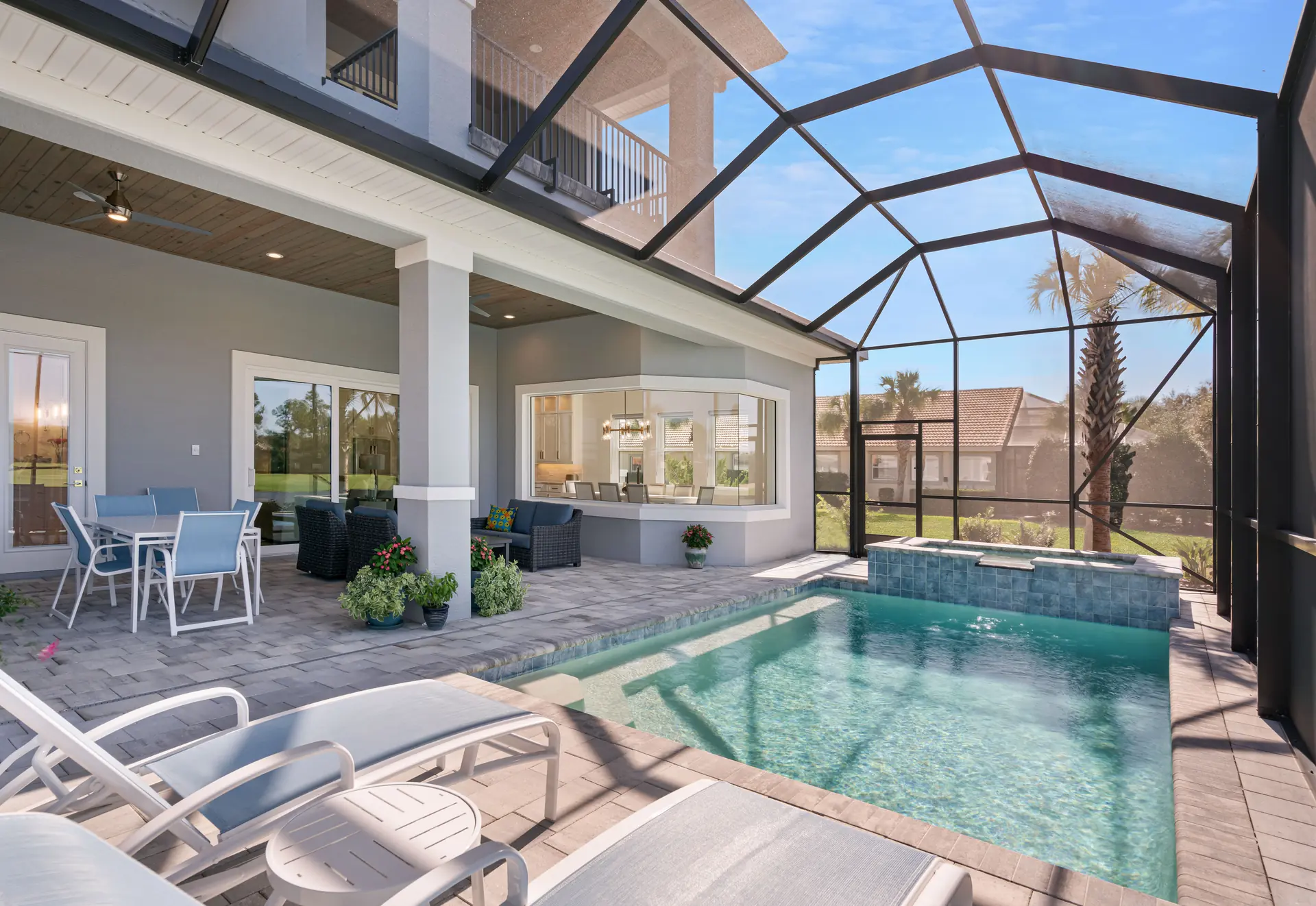 Screened pool and spa beneath a wood-accented lanai