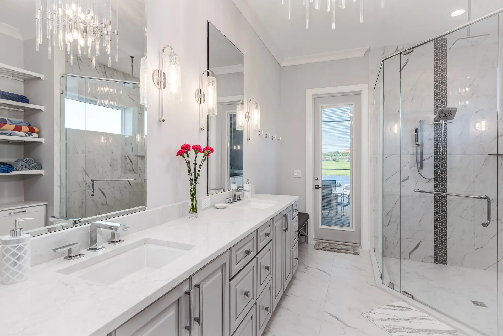 Primary bathroom with custom cabinetry and marble finishes