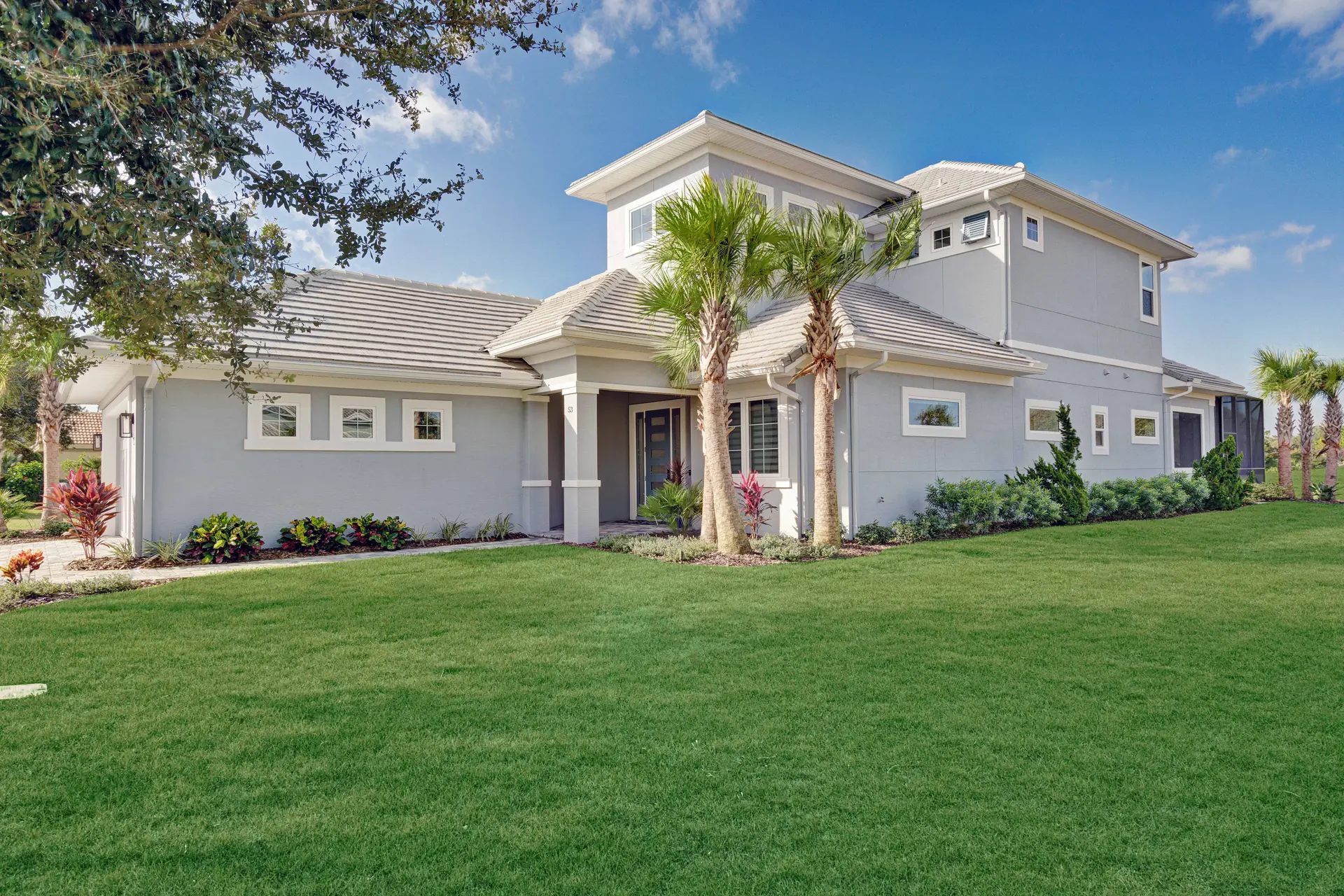 Rear elevation of a custom home across a broad green lawn