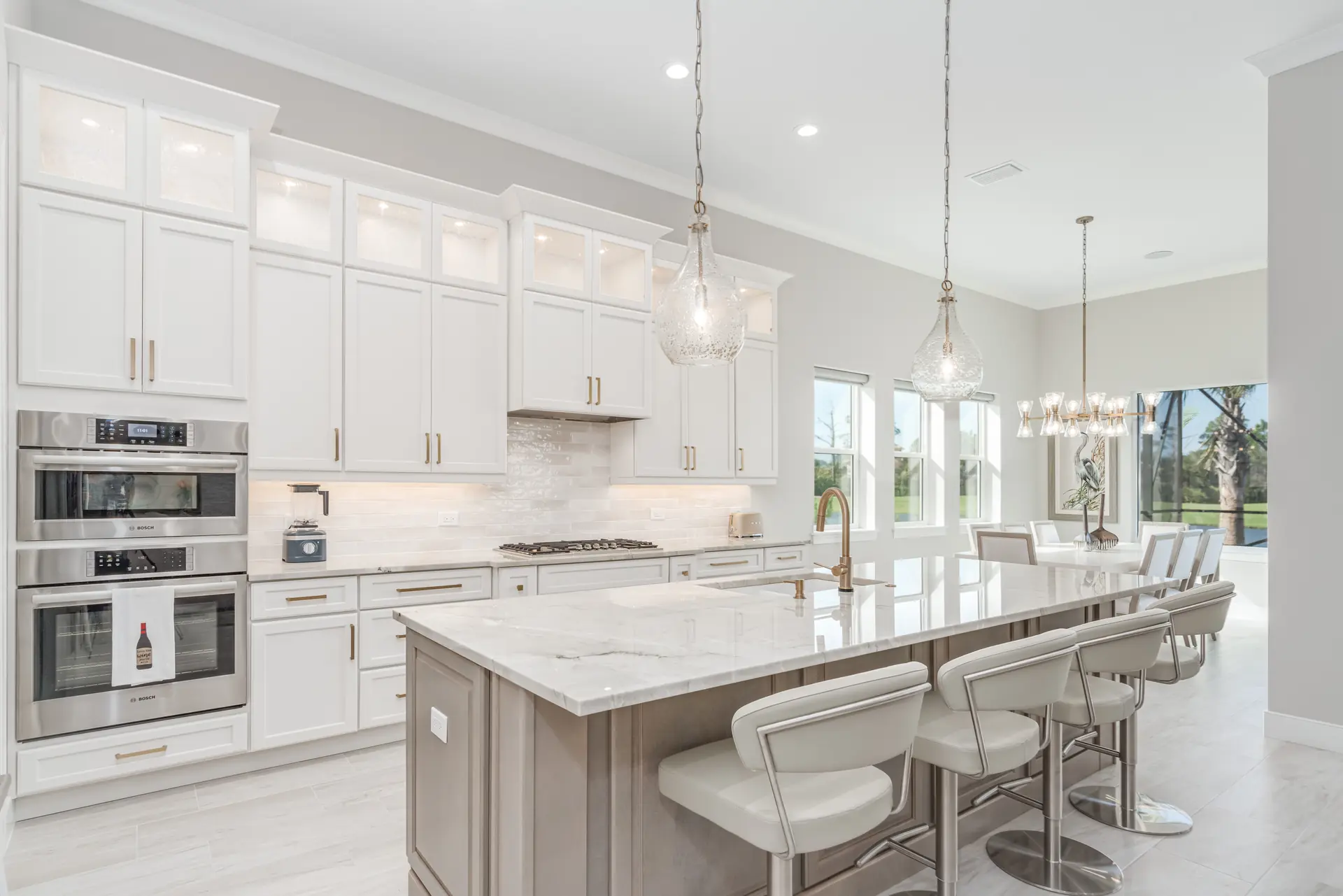 White custom kitchen with statement pendants and island seating